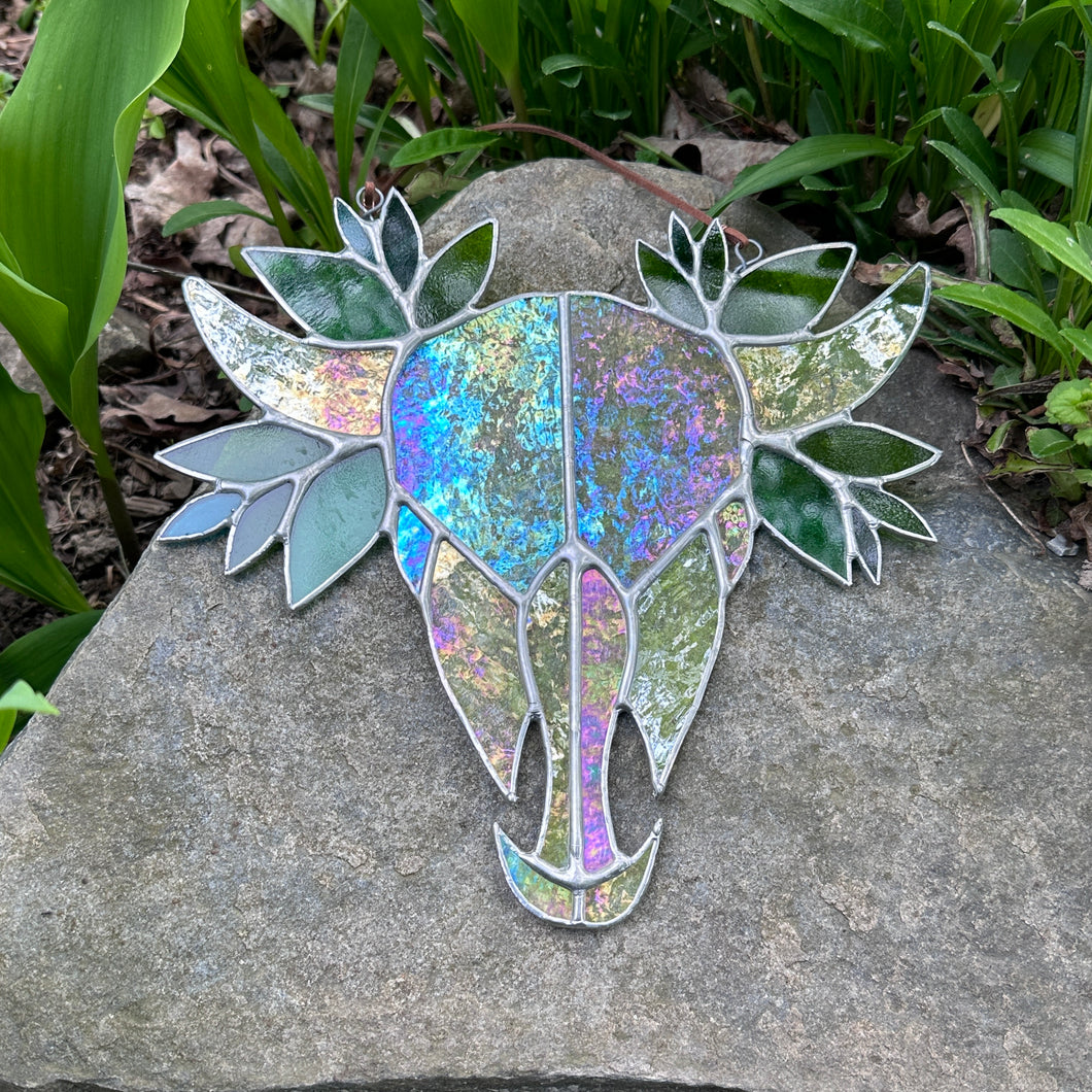 Iridescent skull with leaves